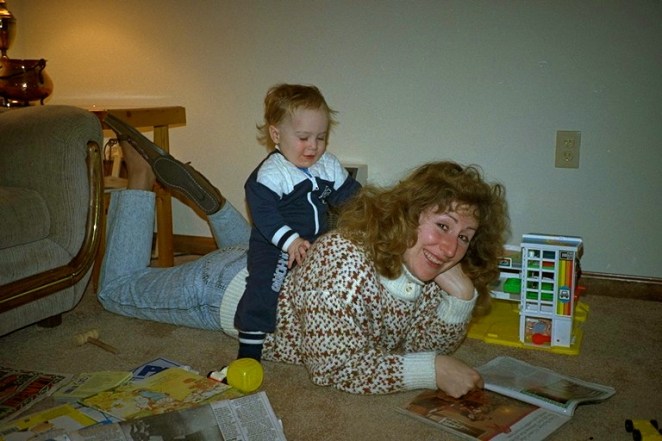 My mom reading with my older brother on her back. She loved her family and her books. 